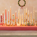 Pink and white spiral taper candles in gold holders for holiday table decor from Parte Haus party supply store in Bethesda MD