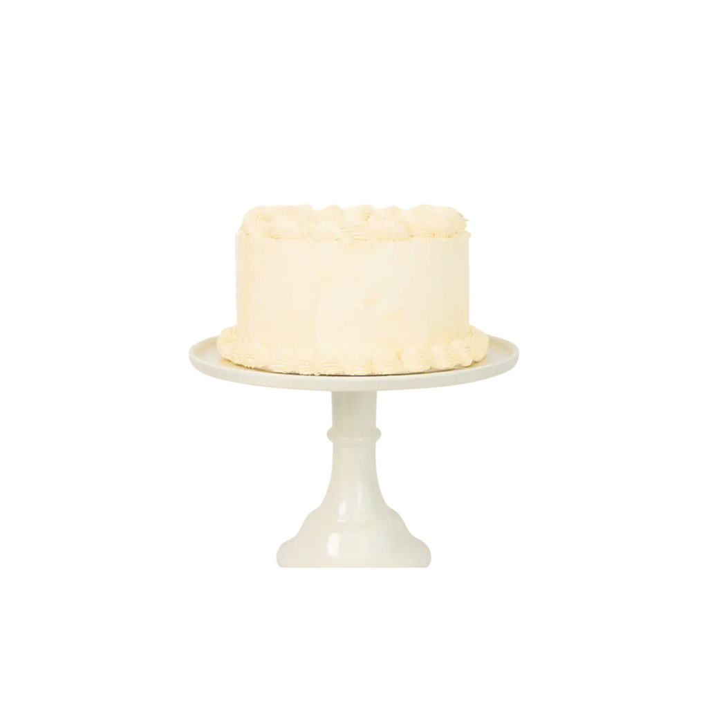 White cake stand with classic round vanilla frosted cake for birthdays from Parte Haus party supply store in Bethesda Maryland
