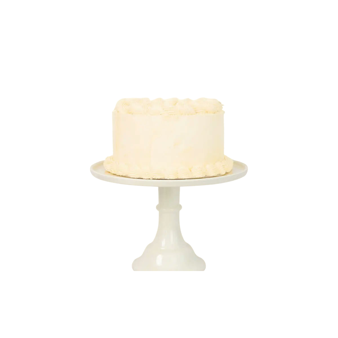 White cake stand with classic round vanilla frosted cake for birthdays from Parte Haus party supply store in Bethesda Maryland