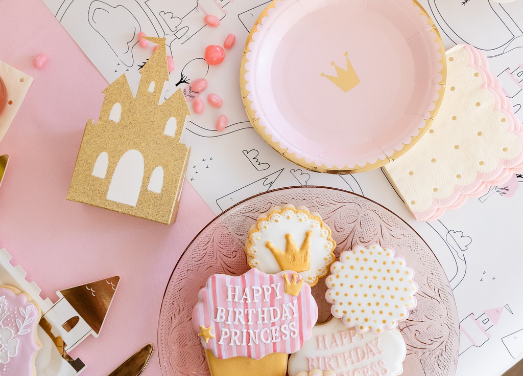 Pink and gold princess themed birthday plates cookies and castle decor for birthday from Parte Haus party supply store in Bethesda MD
