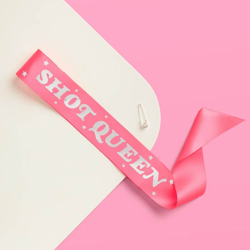 Pink Shot Queen sash with bold white letters bachelorette accessory from Parte Haus party supply store in Bethesda Maryland