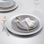 Gray and gold tableware set with elegant plates flatware and monogram napkin for dinner celebration from Parte Haus party supply store in Bethesda Maryland