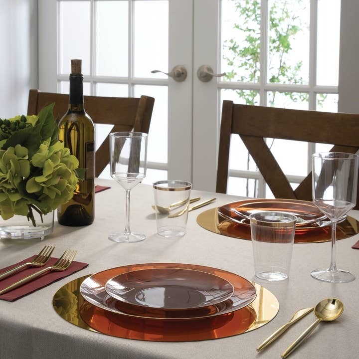 Gold and amber dinnerware set with wine glasses elegant table setting for dinner from Parte Haus party supply store in Bethesda MD.