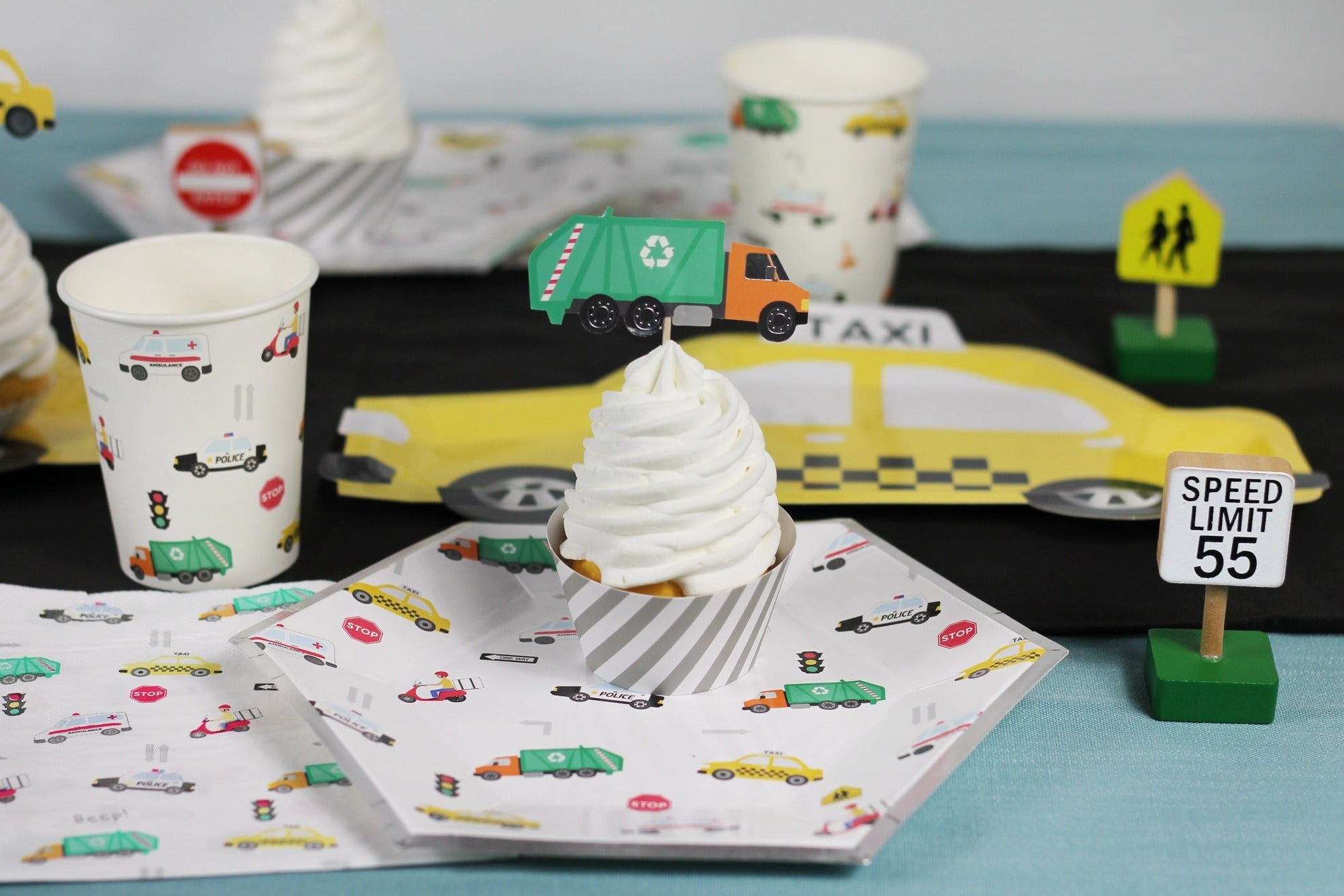 Multicolor vehicle themed plates cups and cupcake topper for kids birthday from Parte Haus party supply store in Bethesda MD.