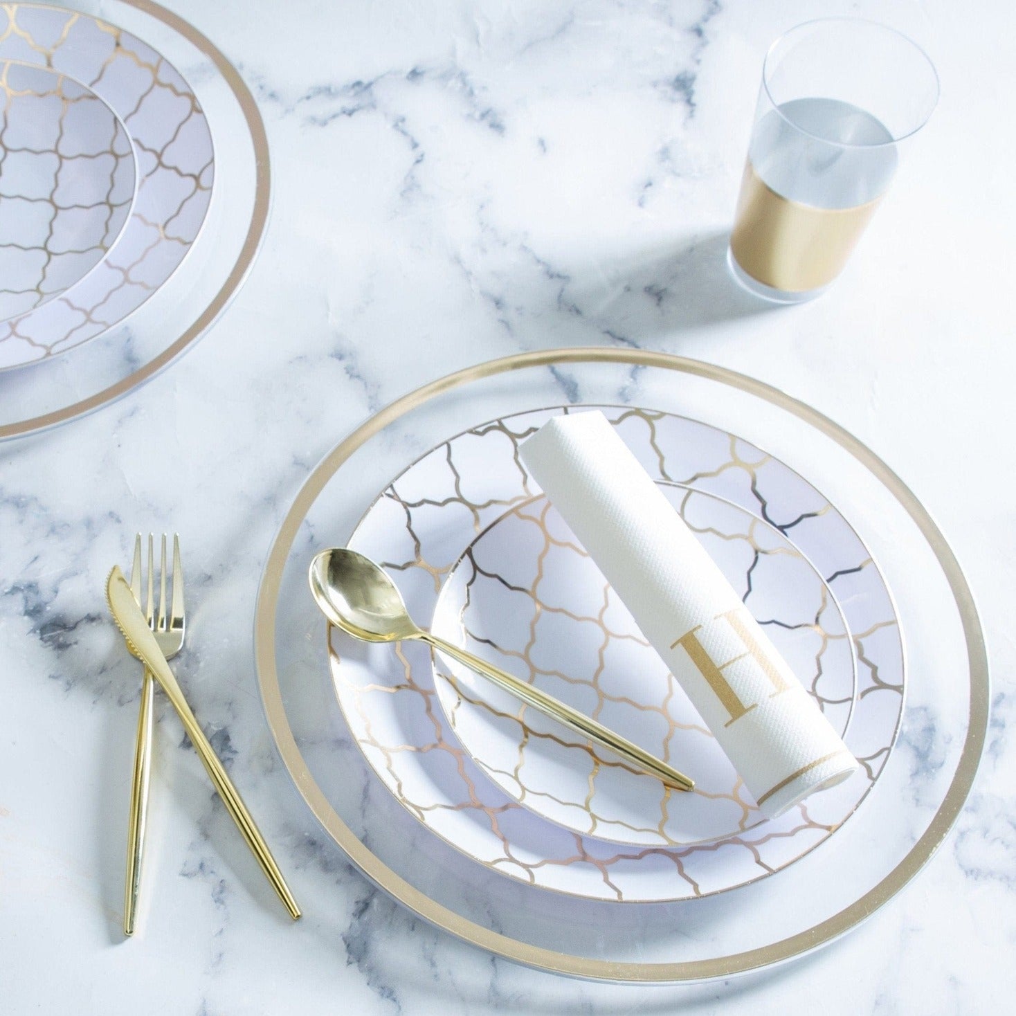Gold and white dinnerware set with geometric pattern elegant table setting for celebration from Parte Haus party supply store in Bethesda MD