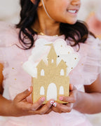 Gold castle napkin holder with white napkins for princess birthday from Parte Haus party supply store in Bethesda Maryland