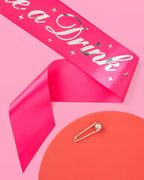 Hot pink sash with silver lettering and safety pin for bachelorette from Parte Haus party supply store in Bethesda MD