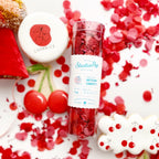 Red cherry confetti with cherry themed cookies for birthday decor from Parte Haus party supply store in Bethesda MD