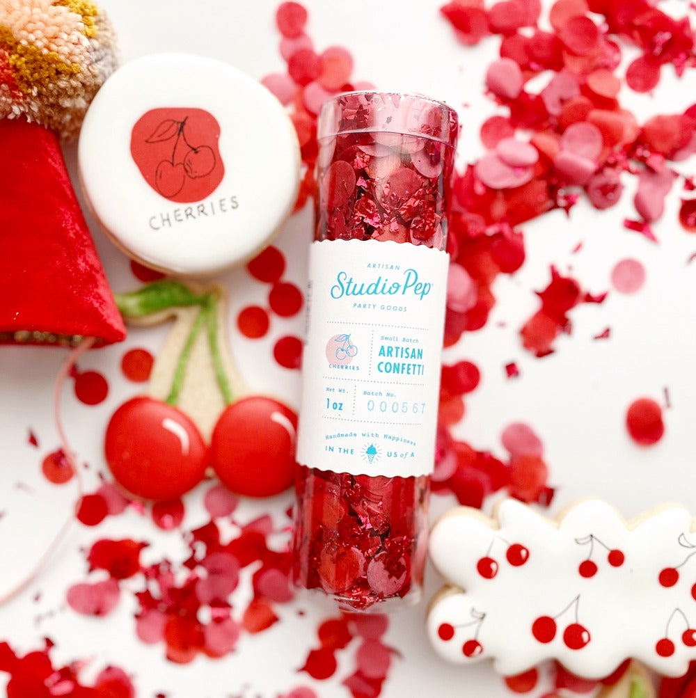 Red cherry confetti with cherry themed cookies for birthday decor from Parte Haus party supply store in Bethesda MD