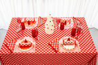 Red and white Christmas table setup with festive plates reindeer decor and tree centerpiece from Parte Haus party supply store in Bethesda Maryland