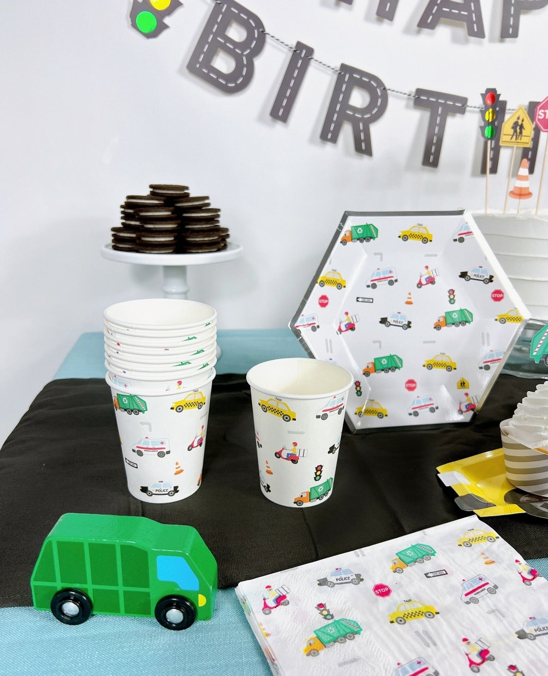 White transportation themed paper cups plates and napkins with cars trucks and street signs birthday party from Parte Haus party supply store in Bethesda Maryland