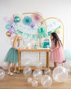 Pastel balloon arch and paper fans with mermaid birthday backdrop from Parte Haus party supply store in Bethesda MD