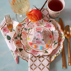 Floral pastel plates with gold trim and rose napkin tea party table setting from Parte Haus party supply store in Bethesda Maryland