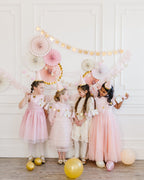 Pink and gold princess birthday decorations with girls in dresses from Parte Haus party supply store in Bethesda MD