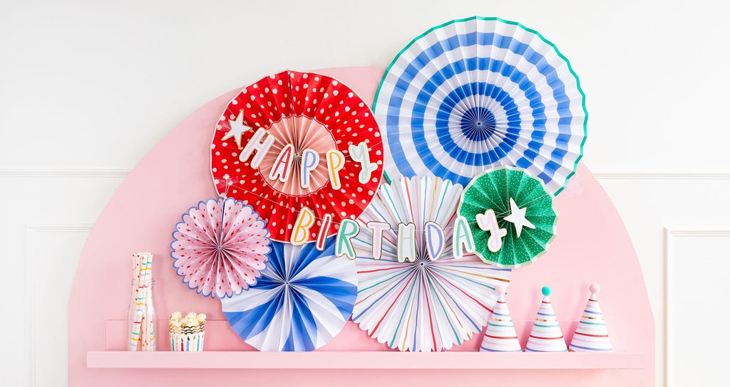 Colorful paper fan decorations happy birthday banner hats and treats for birthday from Parte Haus party supply store in Bethesda Maryland