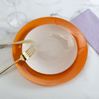 Orange charger plate and gold cutlery elegant tableware for celebration from Parte Haus party supply store in Bethesda MD.