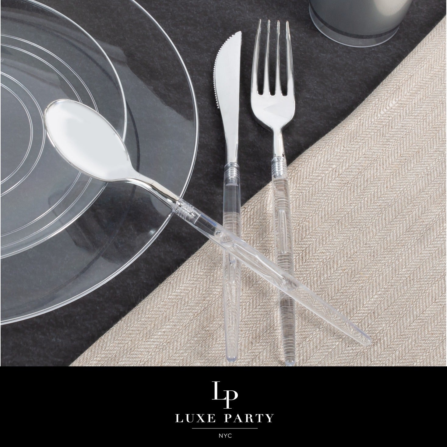 Clear plastic cutlery set with plates on a black and beige table setting for elegant events from Parte Haus party supply store in Bethesda MD
