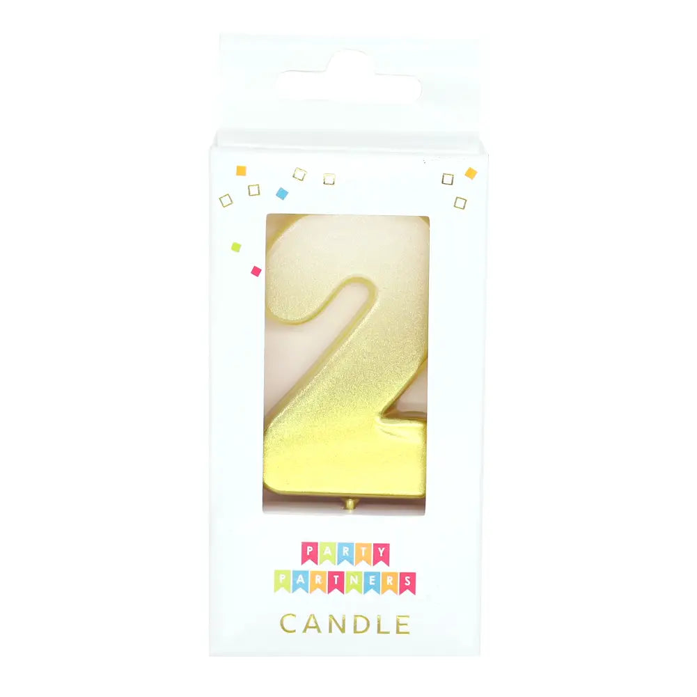 Gold number 2 candle in packaging for birthday from Parte Haus party supply store in Bethesda Maryland