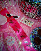 Pink sash sunglasses and cups for bachelorette party from Parte Haus party supply store in Bethesda Maryland