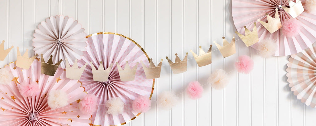 Pink and gold princess crown garland and paper fans birthday decoration from Parte Haus party supply store in Bethesda Maryland