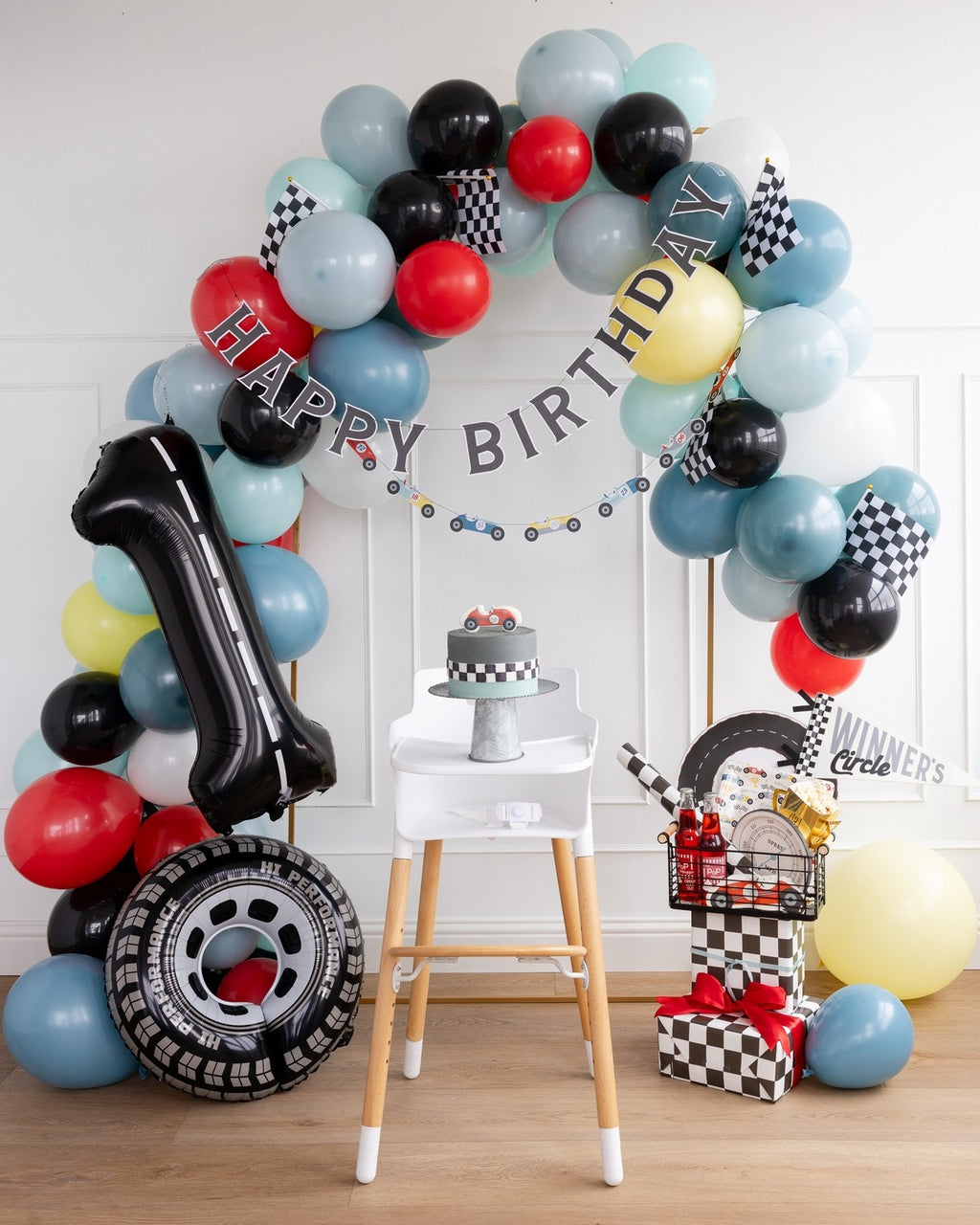 Red blue black and yellow race car birthday balloon arch with checkered flags for kids birthday from Parte Haus party supply store in Bethesda MD