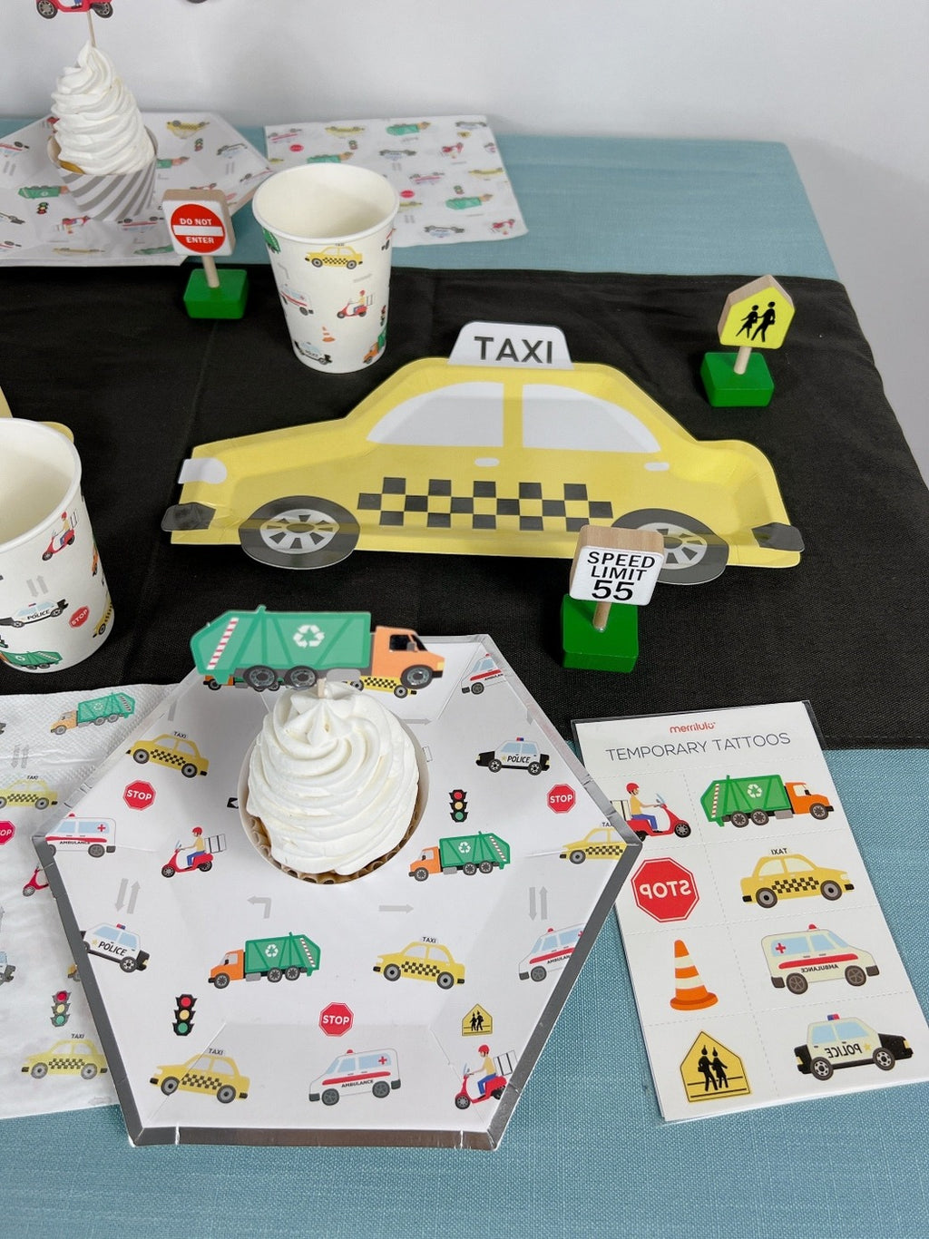 Yellow taxi car shaped plate with traffic themed decorations for kids birthday from Parte Haus party supply store in Bethesda MD