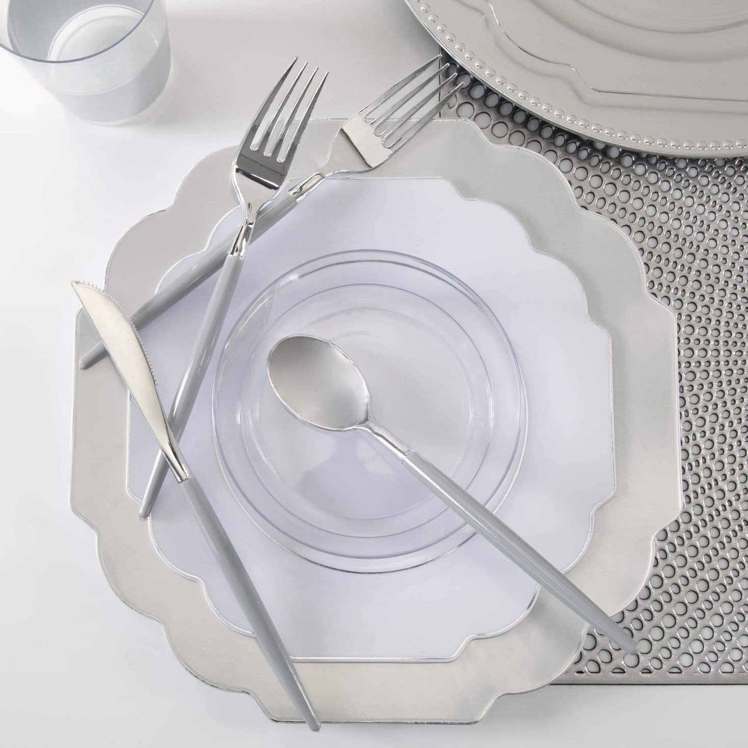 Silver dinnerware set with clear plates and modern cutlery elegant table setting from Parte Haus party supply store in Bethesda, Maryland