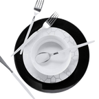 Black and white dinnerware set with geometric pattern and silver cutlery elegant table setting from Parte Haus party supply store in Bethesda Maryland