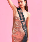 Black birthday sash with glitter lettering on woman in rose gold sequin dress birthday theme from Parte Haus party supply store in Bethesda Maryland