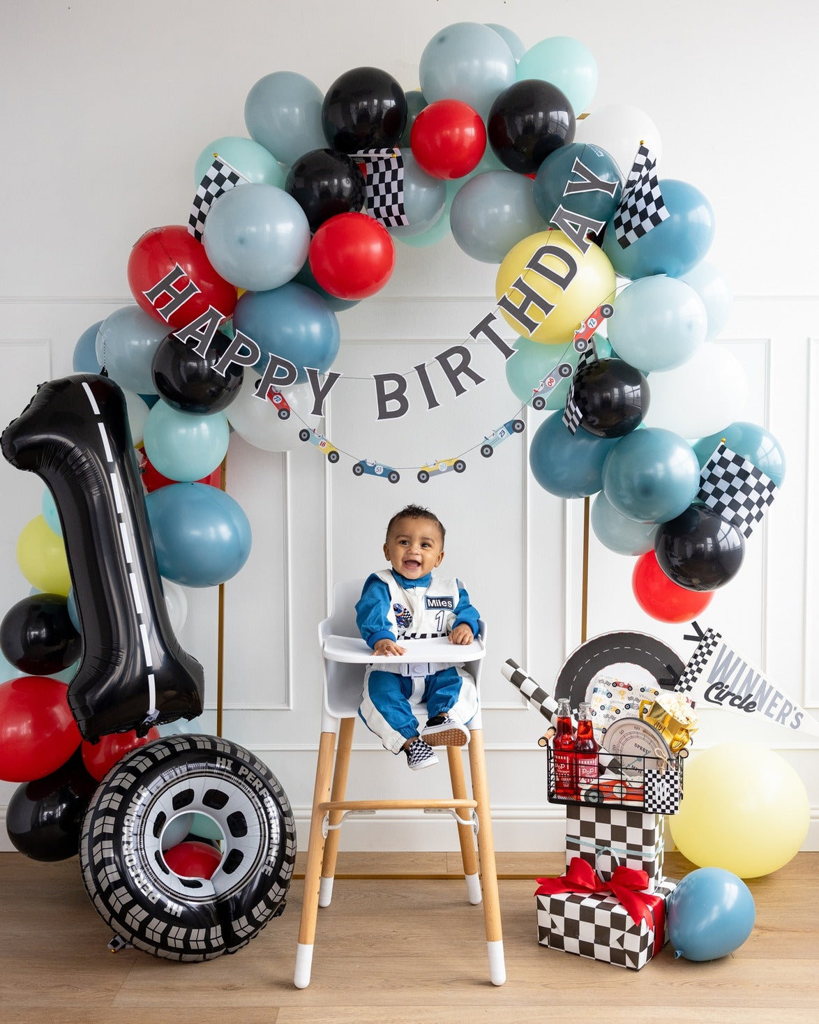 Blue red black race car balloon garland first birthday decor with checkered flags from Parte Haus party supply store in Bethesda MD