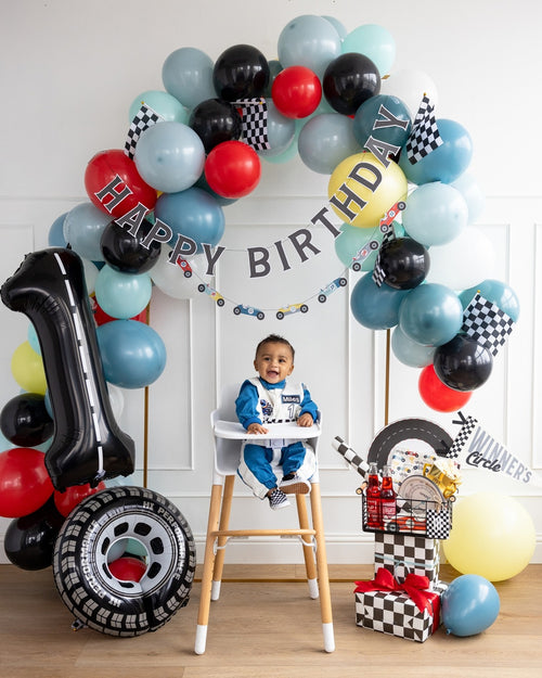 Blue red black race car balloon garland first birthday decor with checkered flags from Parte Haus party supply store in Bethesda MD