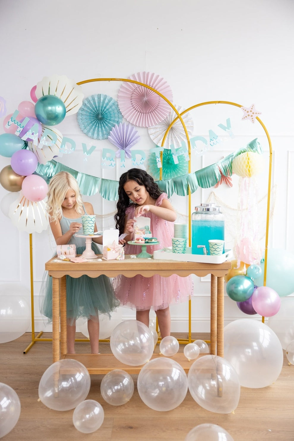 Pastel mermaid birthday decorations with balloons cups and banners from Parte Haus party supply store in Bethesda MD
