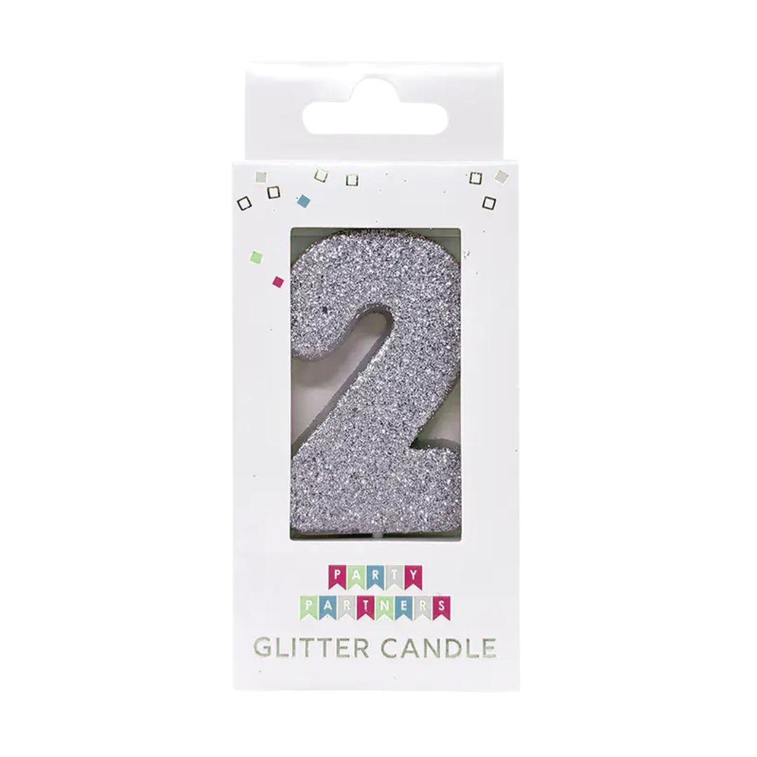 Silver number 2 glitter candle in packaging for birthday celebrations from Parte Haus party supply store in Bethesda Maryland