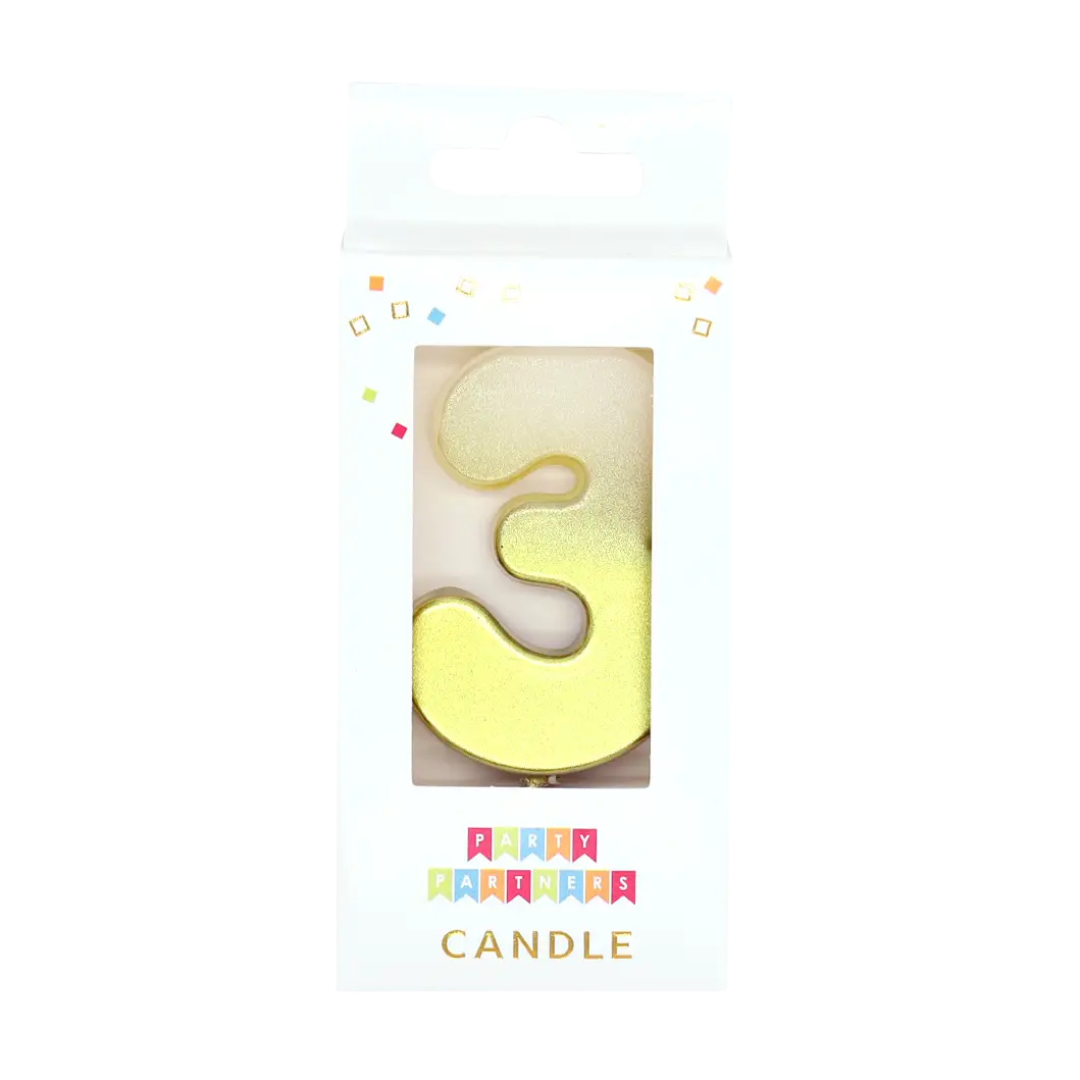 Gold number 3 candle in packaging for birthday celebration from Parte Haus party supply store in Bethesda Maryland