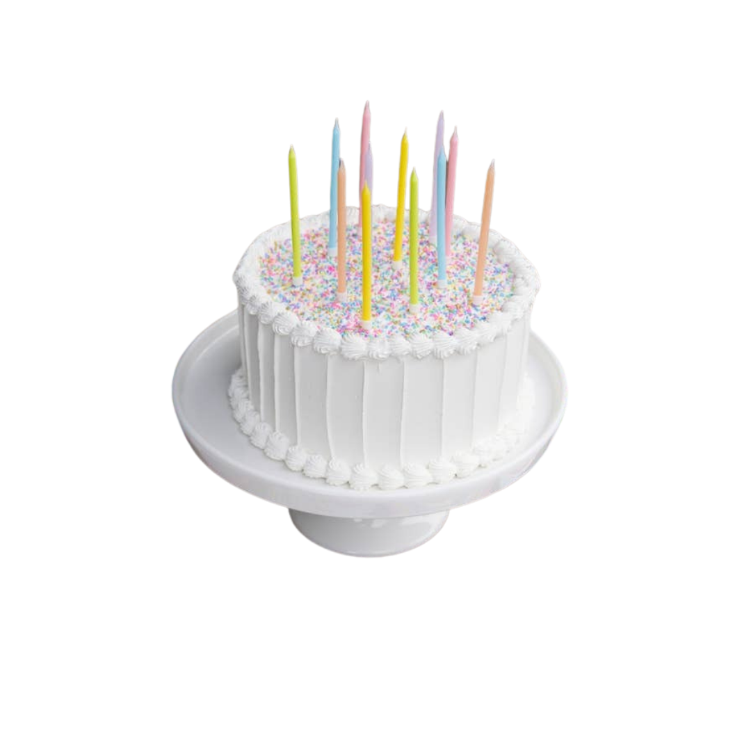 Multicolor birthday candles on white frosted cake with sprinkles for birthday from Parte Haus party supply store in Bethesda MD.