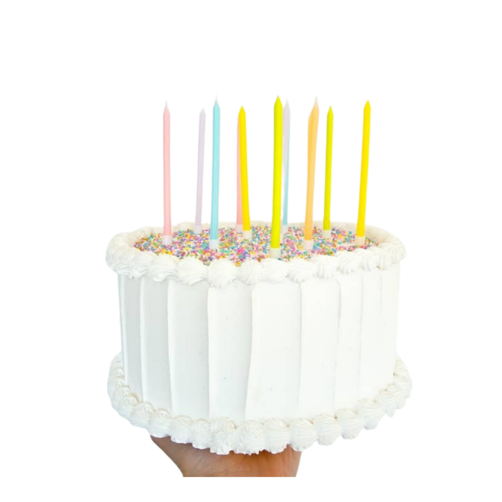 pastel birthday candles set on a white frosted cake celebration decor from Parte Haus party supply store in Bethesda MD