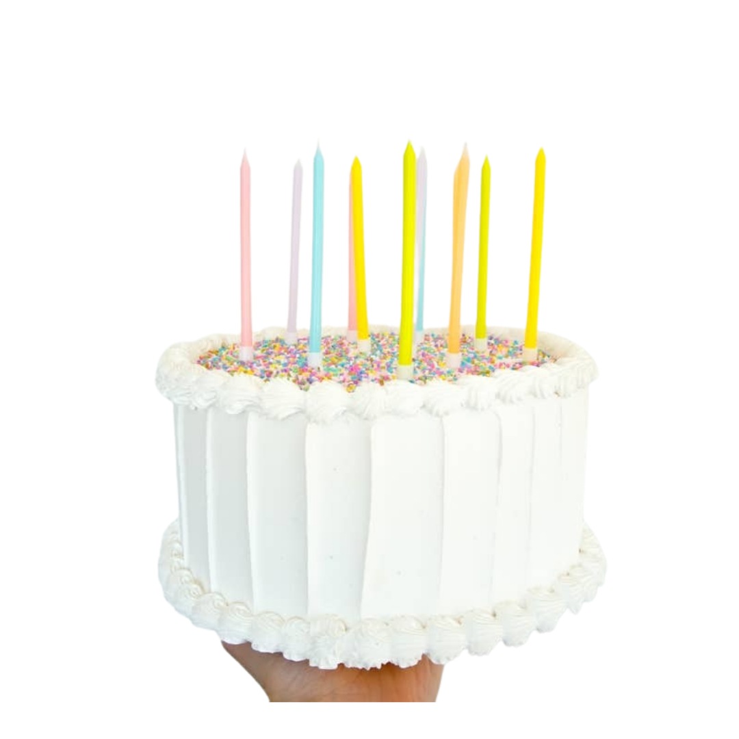 pastel birthday candles set on a white frosted cake celebration decor from Parte Haus party supply store in Bethesda MD