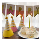 Pastel birthday hats banner and cupcakes with candles birthday decor from Parte Haus party supply store in Bethesda MD