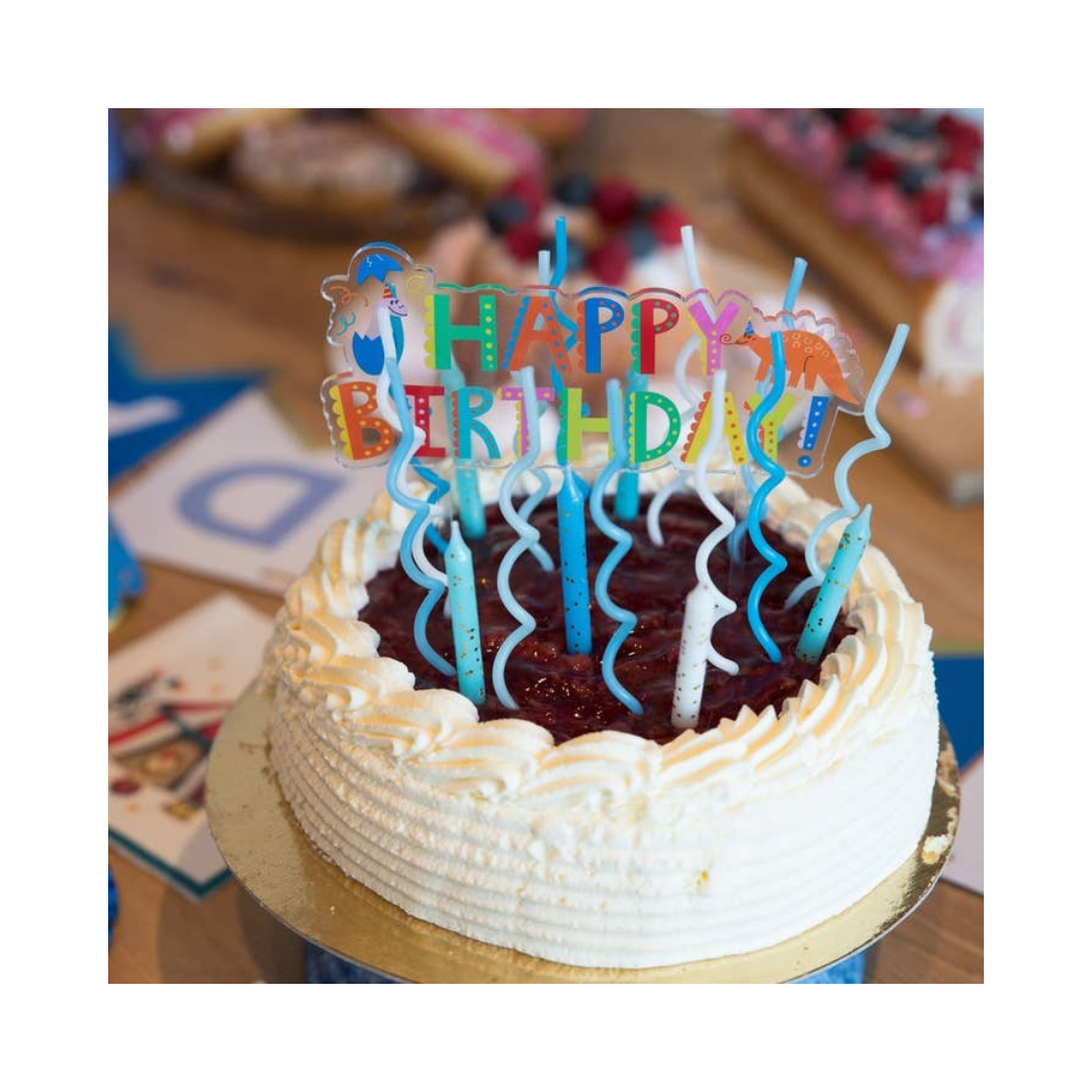 Blue birthday candles cake topper on berry cake for birthday from Parte Haus party supply store in Bethesda Maryland