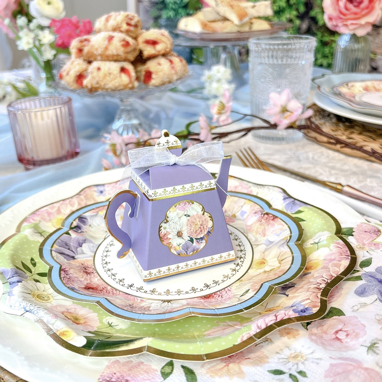 Purple floral teapot favor on scalloped floral plates tea party theme from Parte Haus party supply store in Bethesda MD
