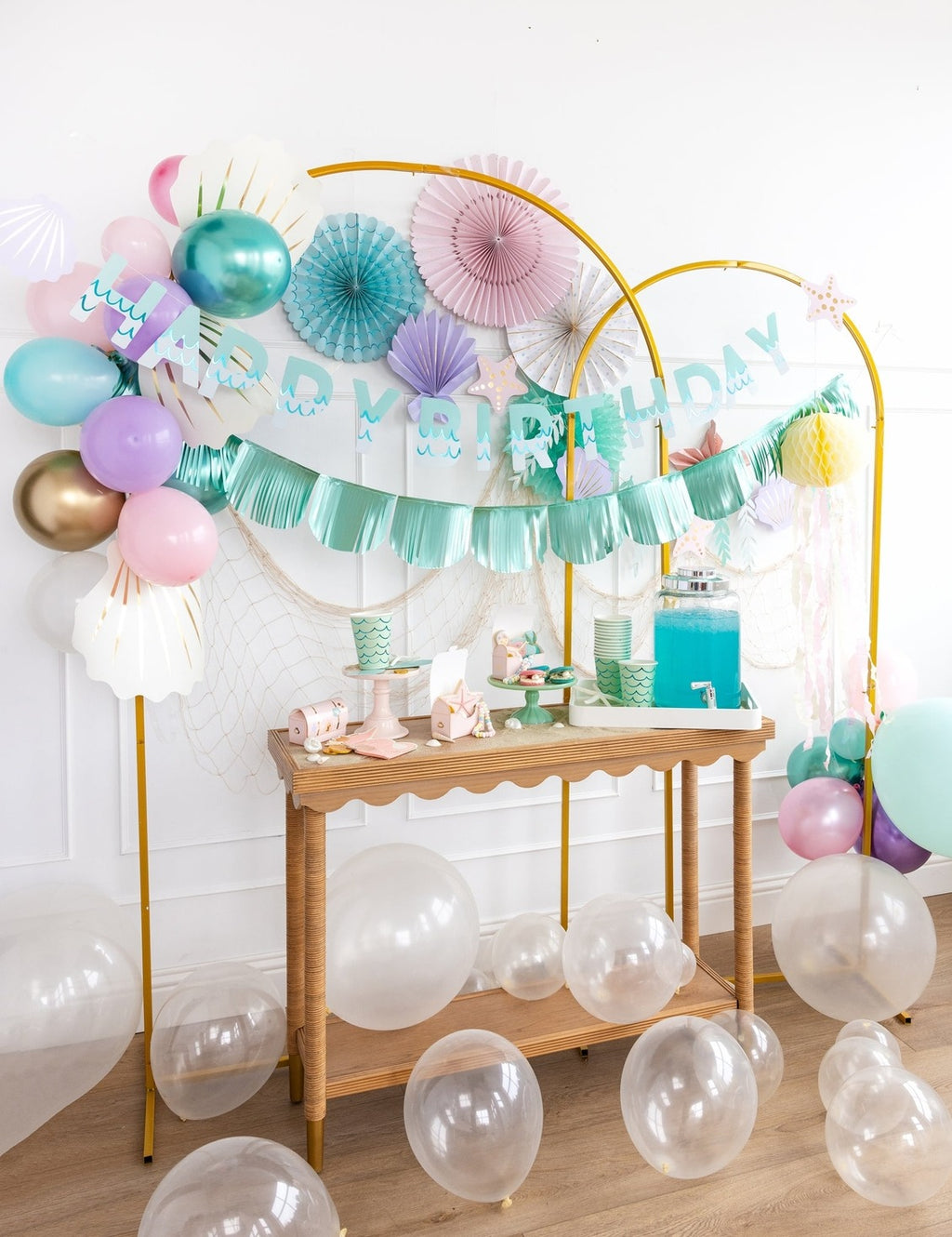 Pastel birthday decorations with balloons tableware and banner undersea theme from Parte Haus party supply store in Bethesda MD