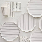 White and silver striped plates cups and napkins with bow accents elegant event from Parte Haus party supply store in Bethesda Maryland