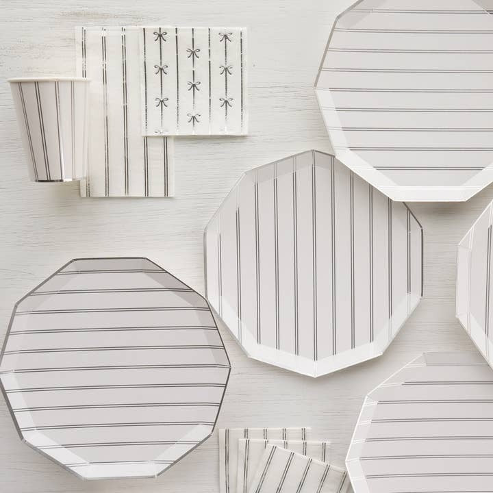 White and silver striped plates cups and napkins with bow accents elegant event from Parte Haus party supply store in Bethesda Maryland