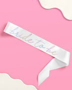 White bride to be sash with pastel lettering for bridal shower from Parte Haus party supply store in Bethesda Maryland