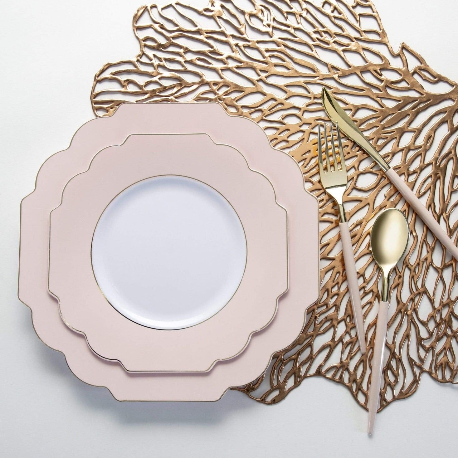 Blush pink plate set with gold cutlery on decorative mat elegant table setting from Parte Haus party supply store in Bethesda Maryland