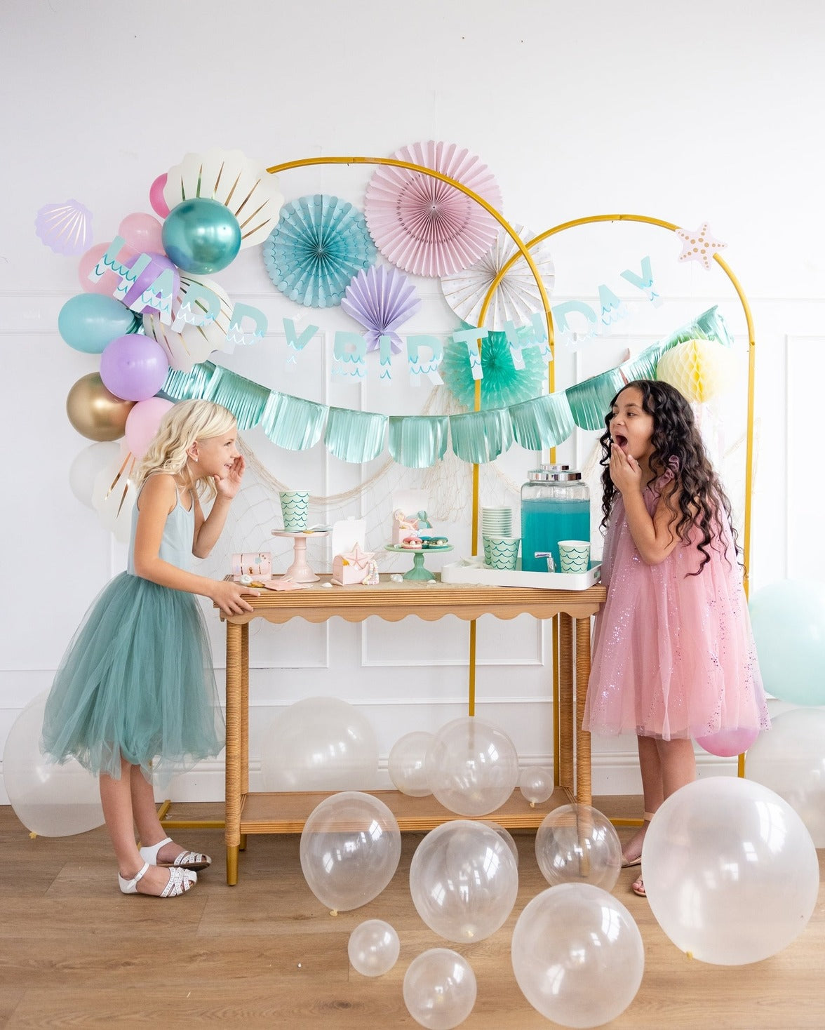 Pastel mermaid birthday decorations with balloons and kids from Parte Haus party supply store in Bethesda Maryland