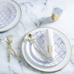Gold and white plate set with geometric pattern and cutlery for elegant celebration from Parte Haus party supply store in Bethesda MD