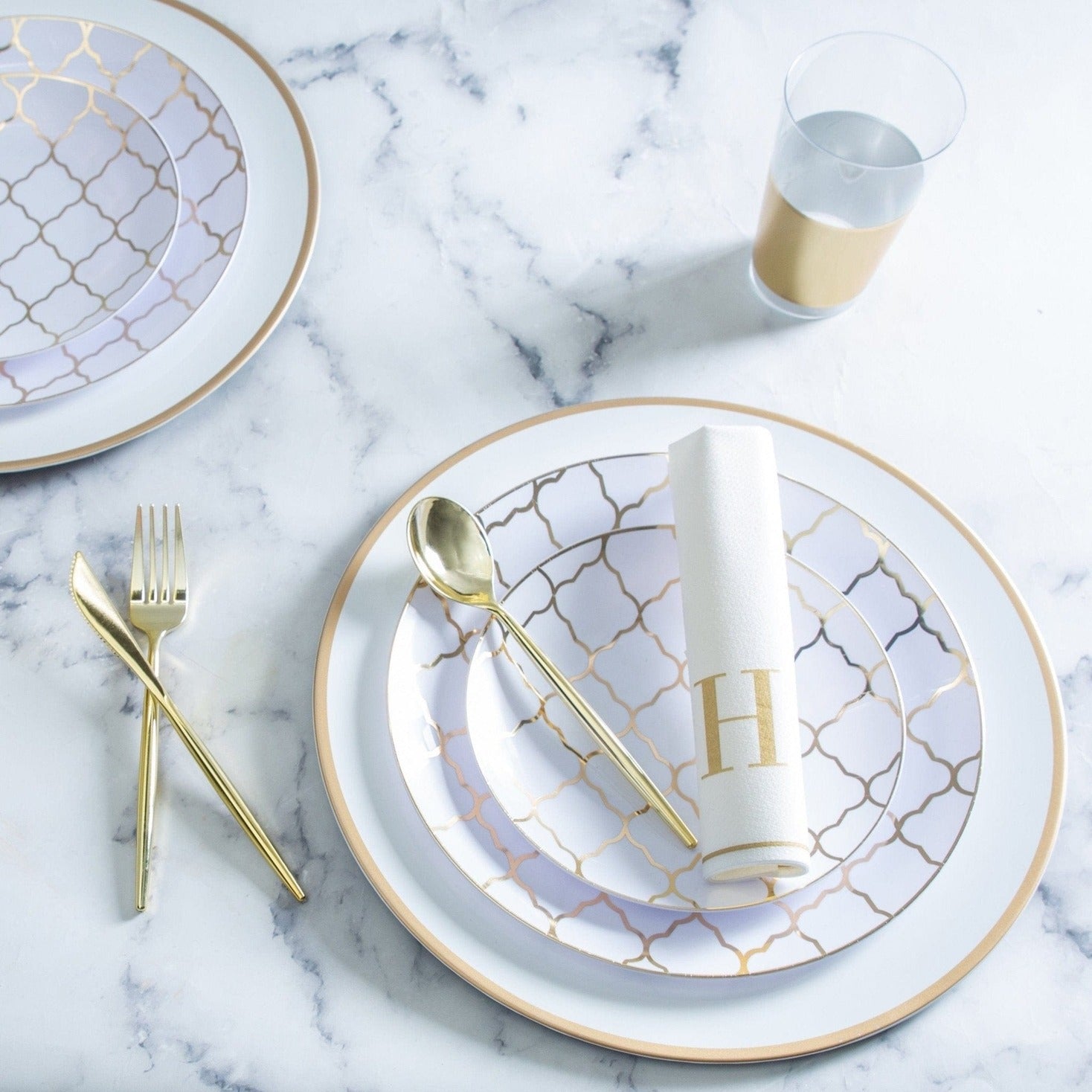 Gold and white plate set with geometric pattern and cutlery for elegant celebration from Parte Haus party supply store in Bethesda MD