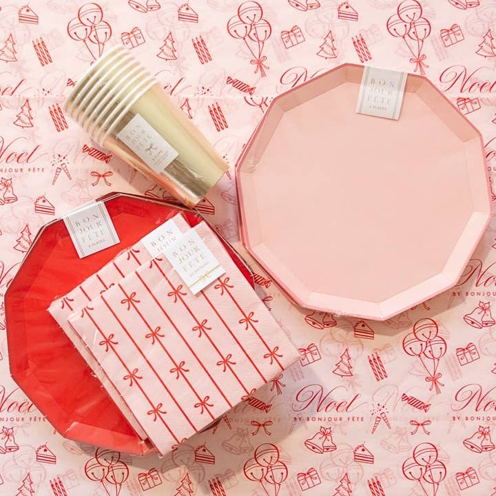 Pink and red plate set gold cups and pink bow napkins for Christmas from Parte Haus party supply store in Bethesda MD