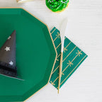 Green plate and napkin with gold accents and black party hat for celebration from Parte Haus party supply store in Bethesda Maryland